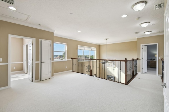 carpeted empty room with ornamental molding, recessed lighting, visible vents, and baseboards