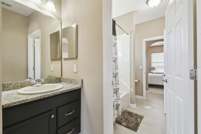 bathroom with shower / bath combo, visible vents, baseboards, tile patterned flooring, and vanity