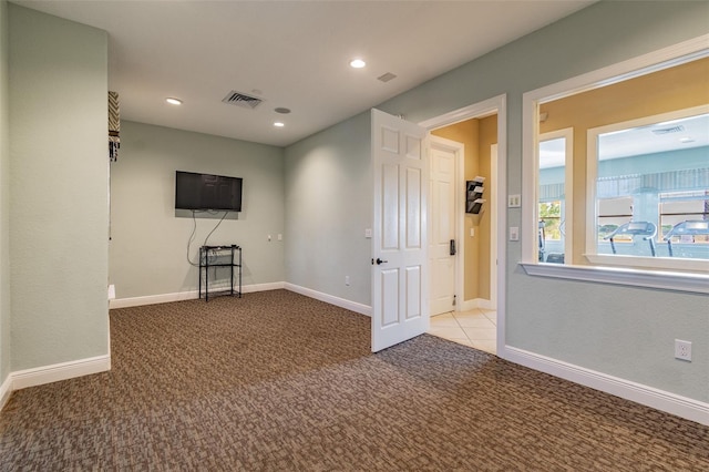 unfurnished room with carpet floors, recessed lighting, visible vents, and baseboards