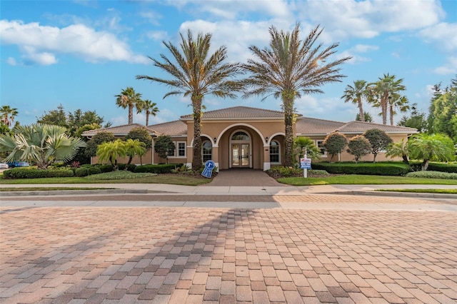 mediterranean / spanish-style home featuring a tile roof and stucco siding