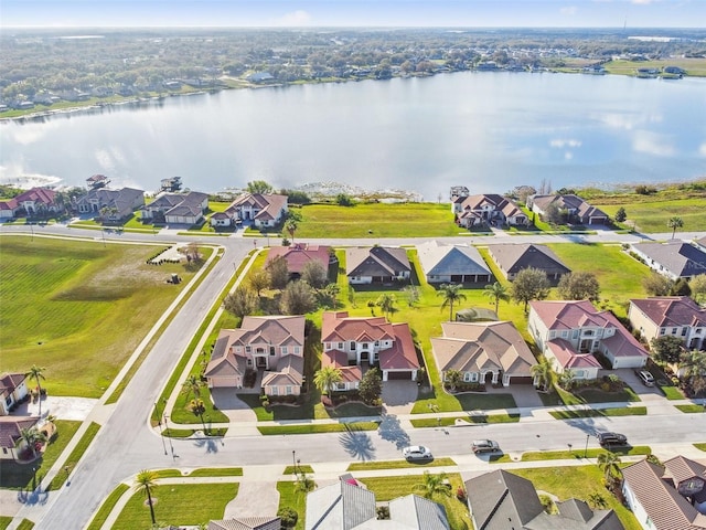 drone / aerial view with a water view and a residential view