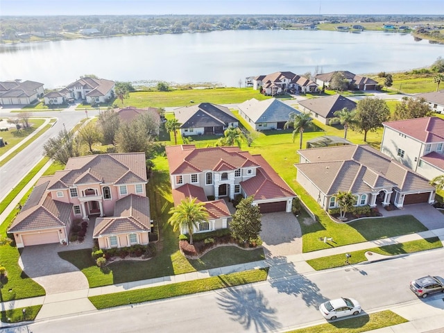 drone / aerial view with a water view and a residential view