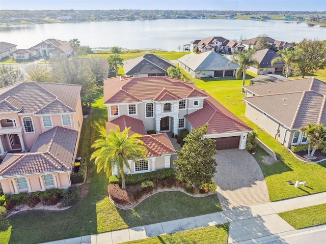 drone / aerial view featuring a water view and a residential view