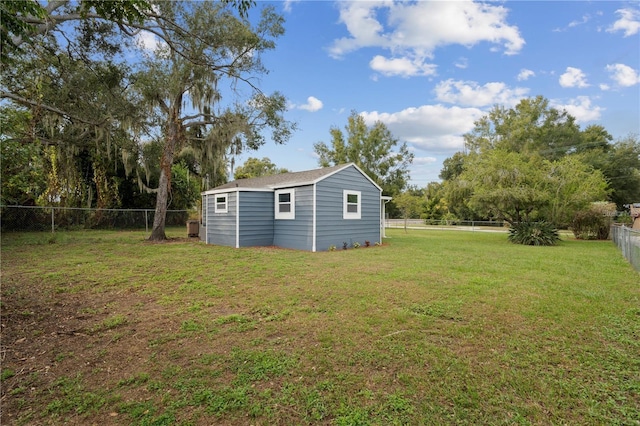 view of yard featuring an outdoor structure and a fenced backyard