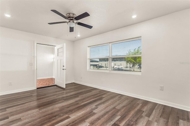 spare room with recessed lighting, dark wood-style flooring, ceiling fan, and baseboards