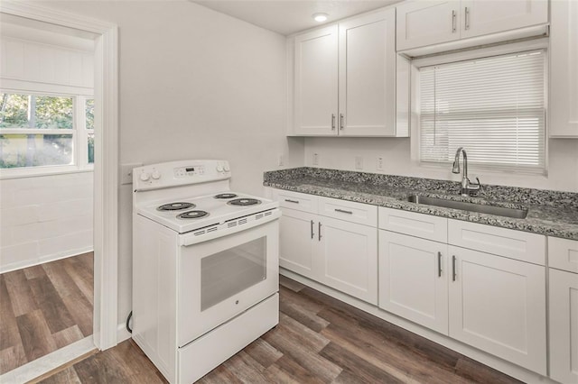 kitchen featuring stone counters, electric range, a sink, white cabinetry, and dark wood finished floors