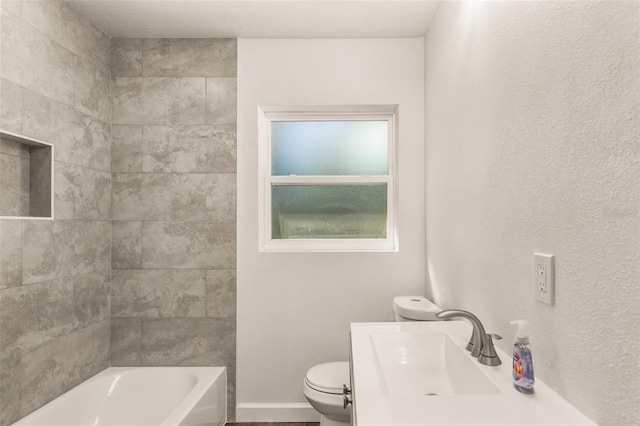 bathroom featuring baseboards, a sink, toilet, and tub / shower combination