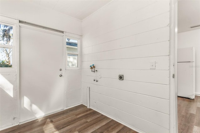 laundry area with laundry area, visible vents, electric dryer hookup, and dark wood-style flooring