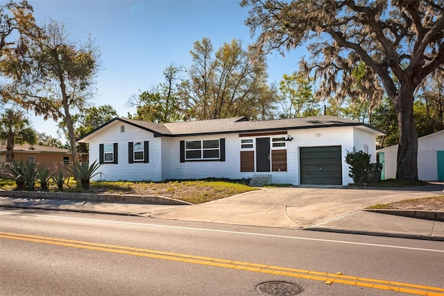 ranch-style home with driveway and an attached garage