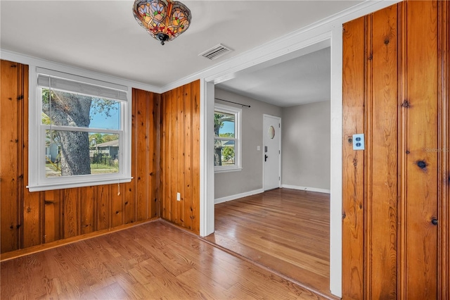 interior space featuring visible vents, baseboards, and wood finished floors