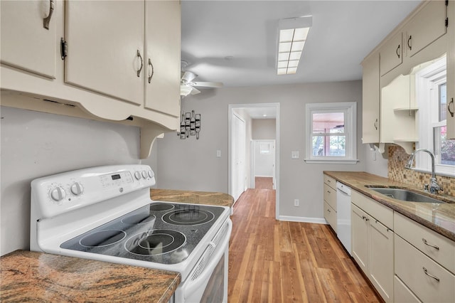 kitchen featuring white appliances, a sink, a ceiling fan, backsplash, and light wood finished floors