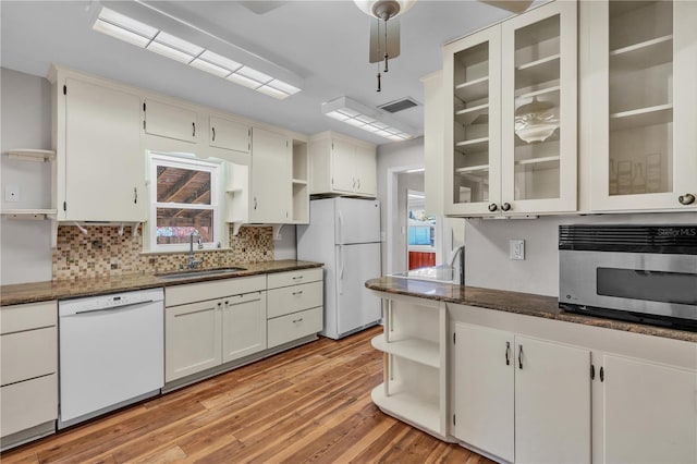 kitchen with white appliances, a sink, visible vents, light wood-style floors, and open shelves