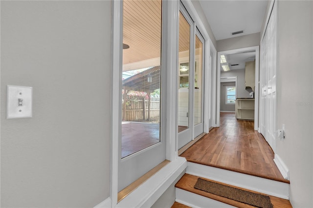 interior space featuring baseboards, visible vents, and wood finished floors