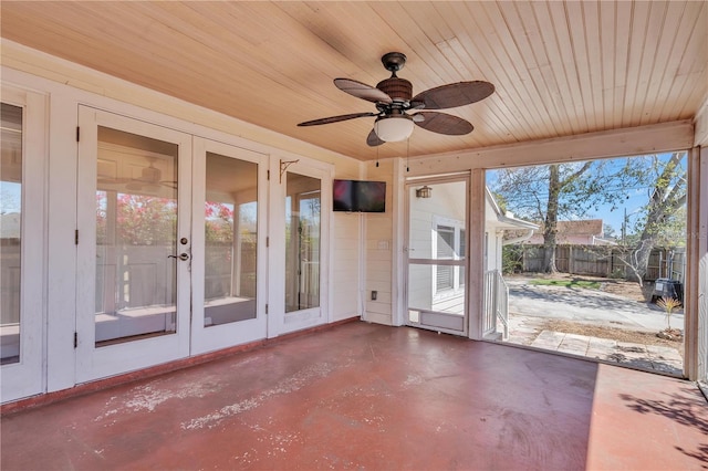 unfurnished sunroom with wood ceiling, ceiling fan, and french doors