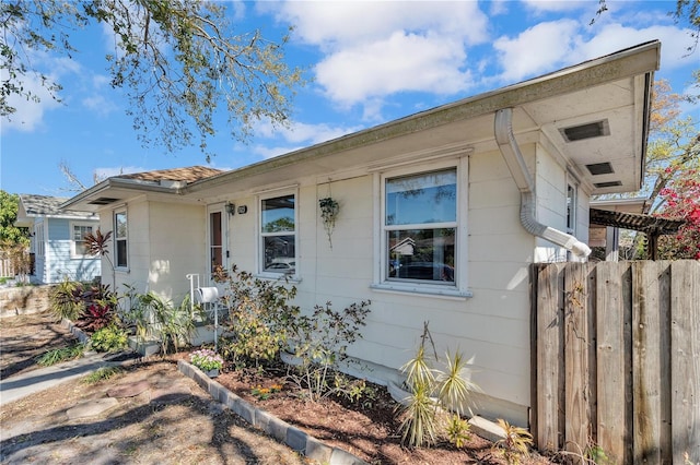 single story home featuring fence