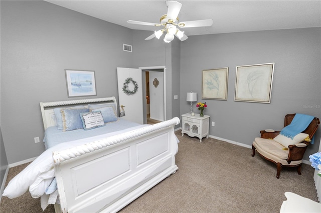 bedroom with lofted ceiling, ceiling fan, light colored carpet, visible vents, and baseboards