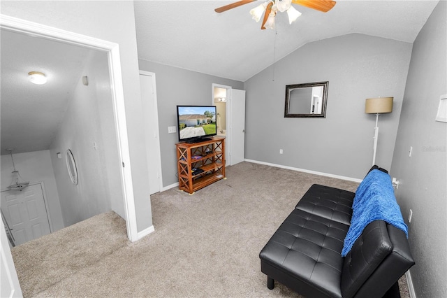 sitting room with lofted ceiling, carpet flooring, a ceiling fan, and baseboards