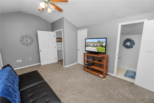 living room with lofted ceiling, carpet floors, a ceiling fan, and baseboards