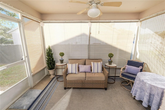 sunroom / solarium featuring ceiling fan