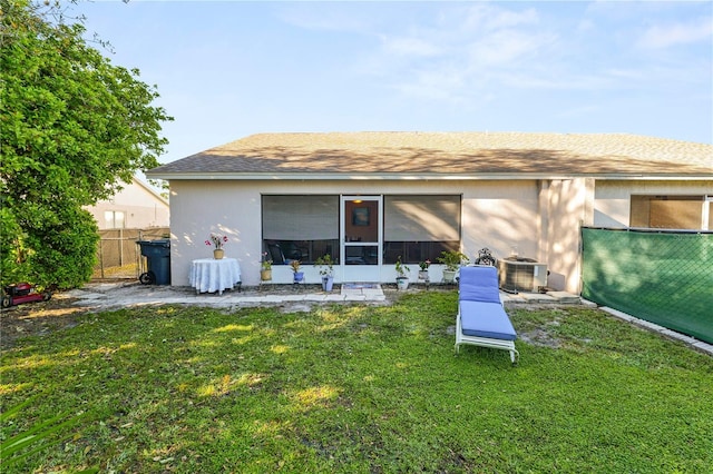 back of house with a yard and fence