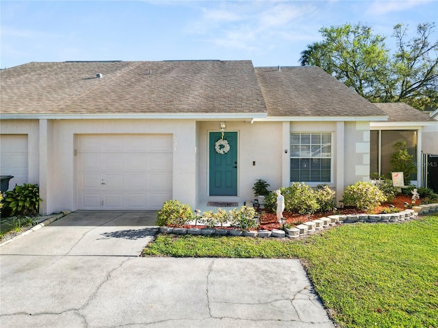 view of front of house featuring roof with shingles, driveway, an attached garage, and stucco siding