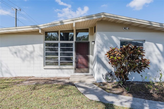 view of exterior entry with concrete block siding