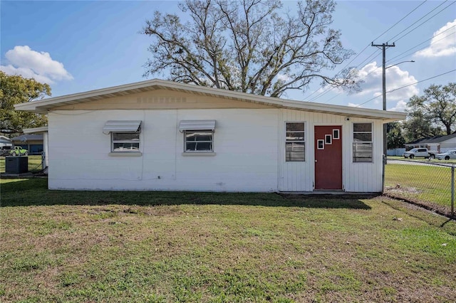 exterior space featuring central AC unit and fence