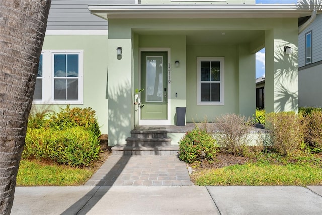 view of exterior entry with stucco siding