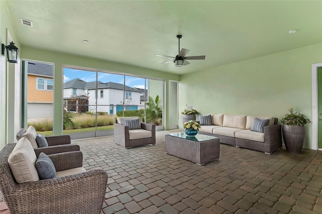 sunroom / solarium featuring visible vents and ceiling fan