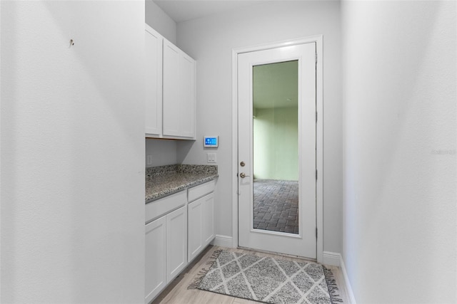 entryway featuring light wood-style floors and baseboards