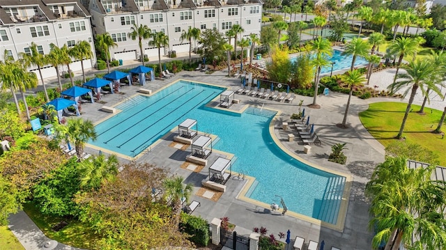 pool with a patio and fence