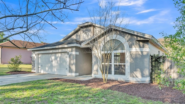 single story home featuring stucco siding, a front lawn, driveway, fence, and a garage