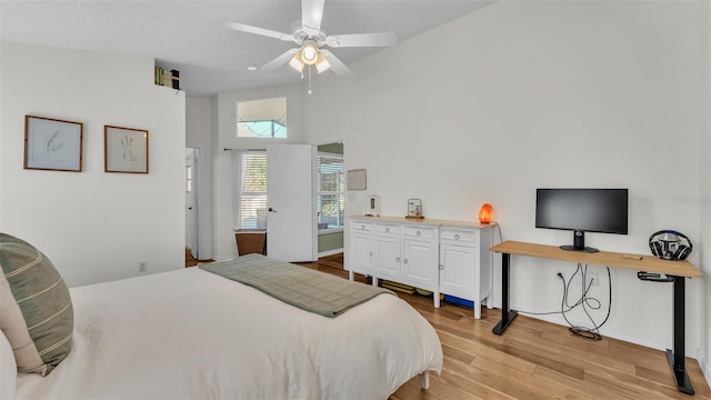 bedroom with baseboards, light wood-type flooring, and ceiling fan