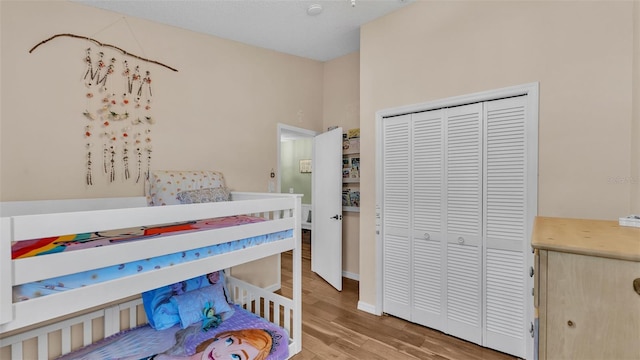 bedroom with a closet and wood finished floors