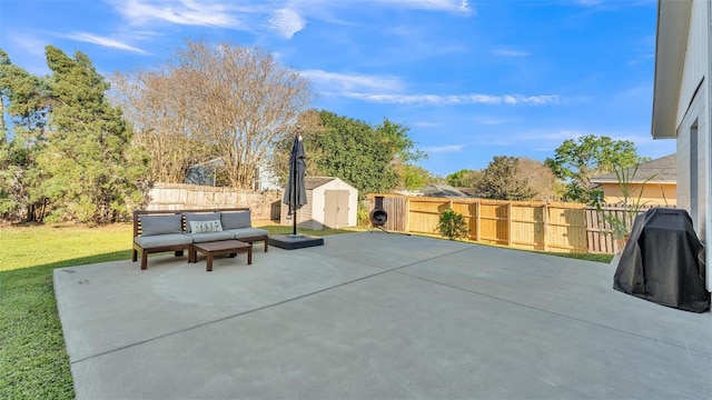 view of patio / terrace featuring an outbuilding, a storage unit, a fenced backyard, and an outdoor living space