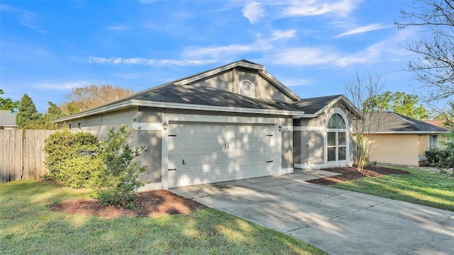 ranch-style home with a front lawn, fence, stucco siding, a garage, and driveway