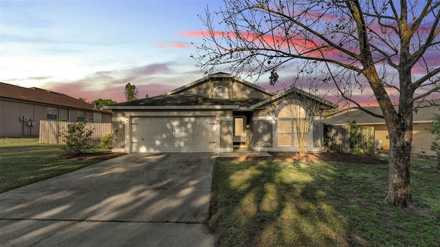 ranch-style house featuring stucco siding, a front lawn, fence, concrete driveway, and a garage