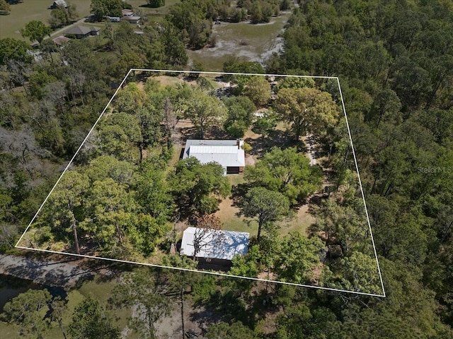 drone / aerial view with a wooded view