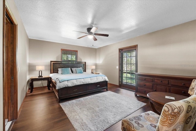 bedroom featuring access to outside, a textured ceiling, dark wood finished floors, baseboards, and ceiling fan