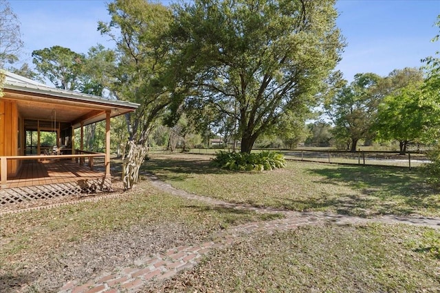 view of yard with a wooden deck and fence