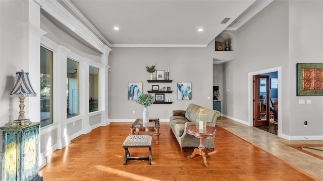 sitting room with recessed lighting, baseboards, visible vents, and ornamental molding