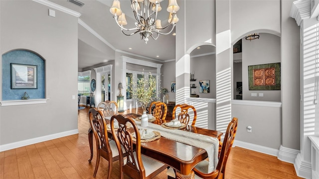 dining room with wood finished floors, baseboards, an inviting chandelier, recessed lighting, and crown molding