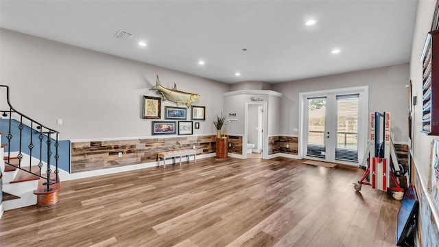 foyer entrance with visible vents, wood finished floors, recessed lighting, wainscoting, and stairs