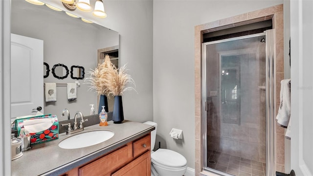 bathroom with vanity, toilet, and a shower stall