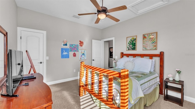 carpeted bedroom featuring visible vents, ceiling fan, attic access, and baseboards