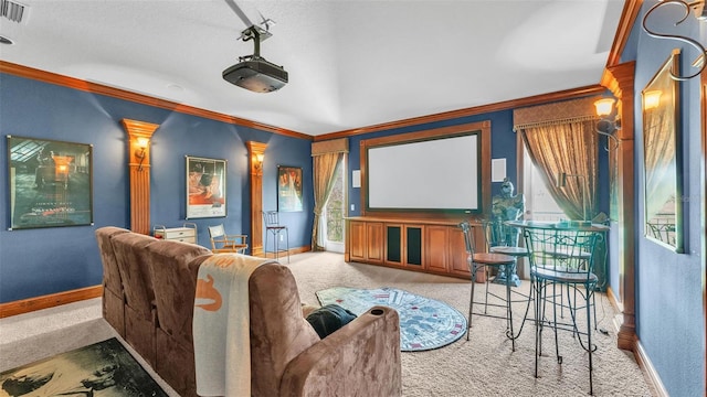 home theater room with baseboards, light colored carpet, and ornamental molding