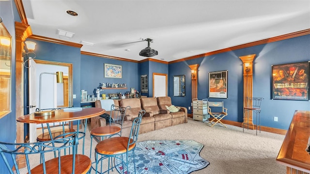 carpeted cinema room featuring visible vents, baseboards, and ornamental molding