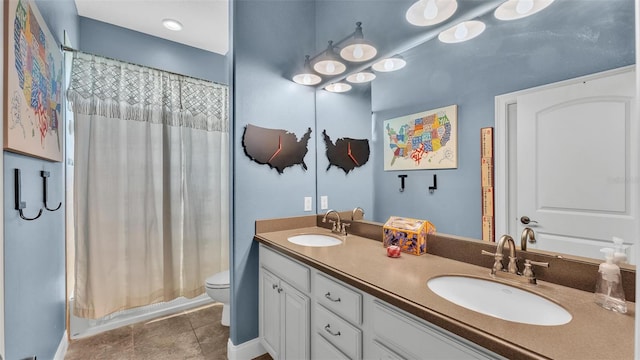 full bath featuring a sink, curtained shower, toilet, and tile patterned flooring