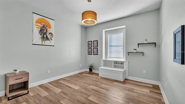 interior space featuring wood finished floors and baseboards