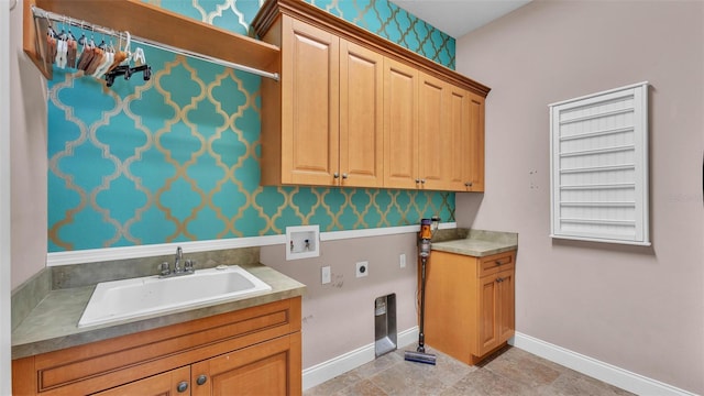 laundry area featuring electric dryer hookup, a sink, cabinet space, baseboards, and hookup for a washing machine